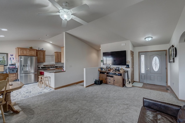 living room with light colored carpet, vaulted ceiling, and ceiling fan