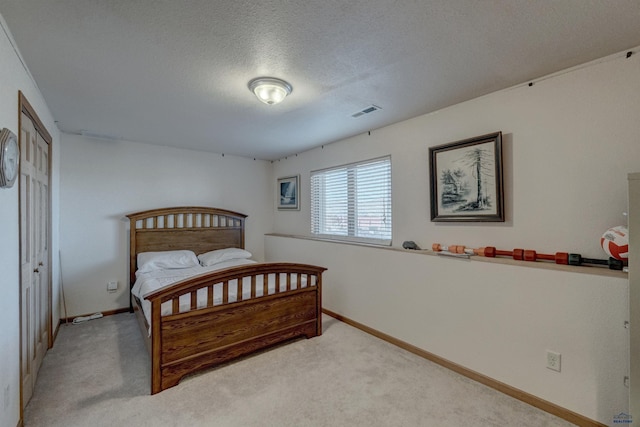 carpeted bedroom with a textured ceiling