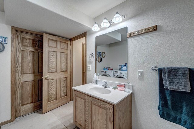 bathroom featuring vanity and independent washer and dryer