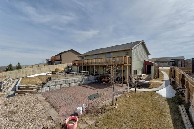 back of property featuring a patio area and a deck