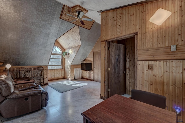 additional living space featuring lofted ceiling, ceiling fan, and wooden walls