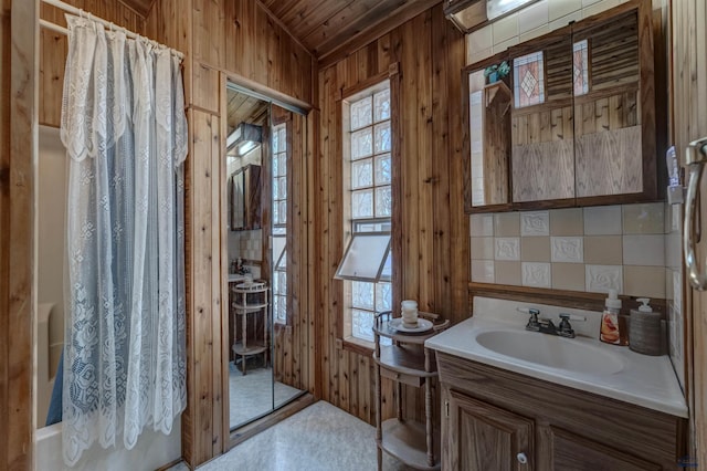 bathroom featuring a shower with curtain, vanity, vaulted ceiling, wooden walls, and wooden ceiling