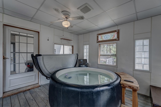 misc room featuring a paneled ceiling, ceiling fan, and hardwood / wood-style floors