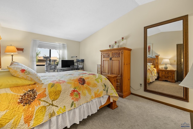 carpeted bedroom with lofted ceiling