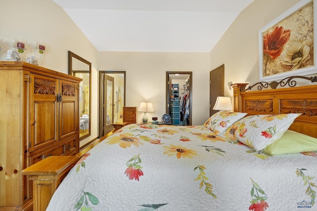 bedroom featuring a walk in closet, a closet, and vaulted ceiling