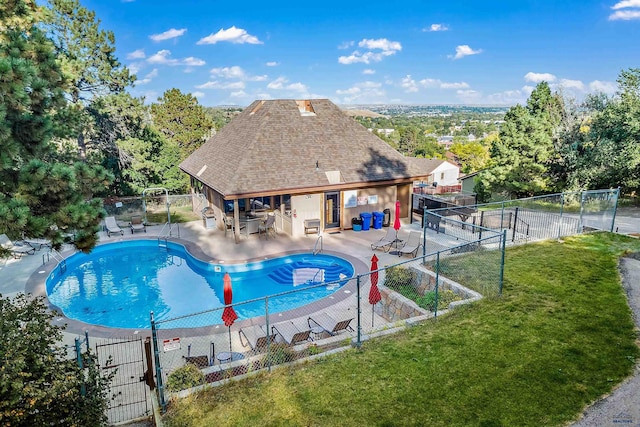 view of swimming pool with a patio area and a yard