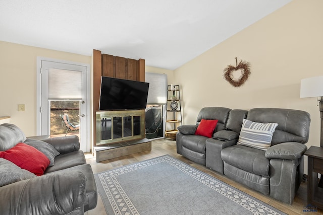 living room with a large fireplace and light hardwood / wood-style flooring