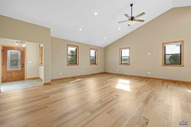 unfurnished living room featuring ceiling fan, high vaulted ceiling, light wood-style flooring, recessed lighting, and baseboards