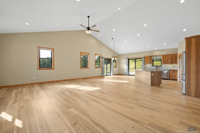 unfurnished living room featuring recessed lighting, light wood-style flooring, a ceiling fan, high vaulted ceiling, and baseboards