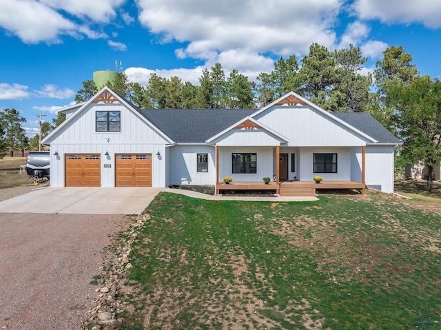 modern farmhouse style home featuring a porch, a garage, and a front lawn