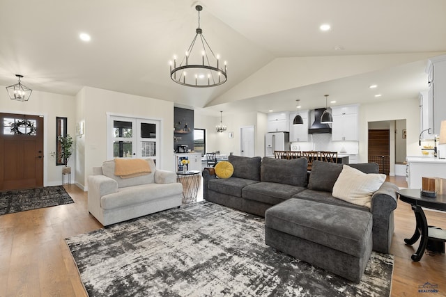 living room with high vaulted ceiling and hardwood / wood-style flooring