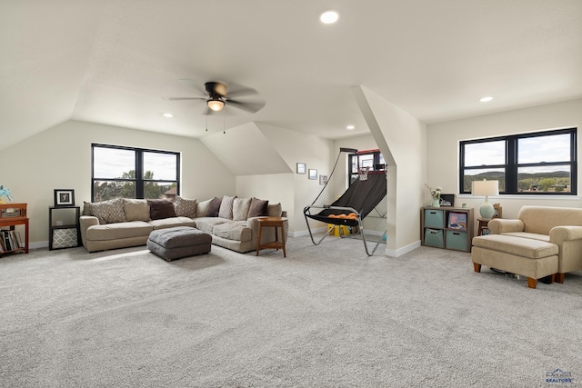 living room featuring ceiling fan, light carpet, and vaulted ceiling