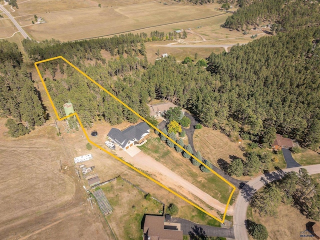 birds eye view of property with a rural view