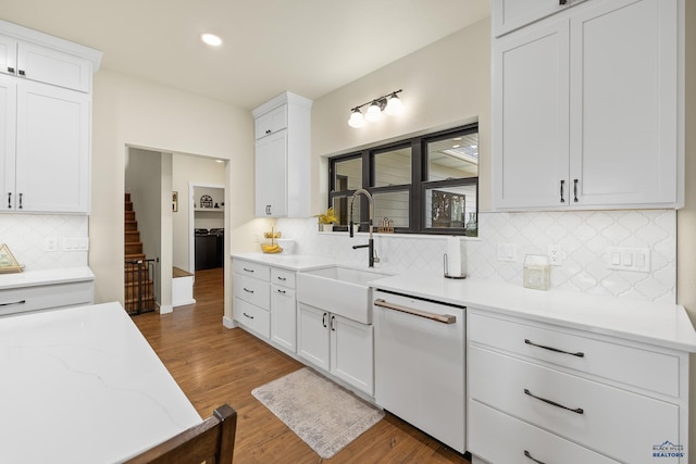 kitchen featuring dark hardwood / wood-style flooring, white cabinetry, sink, and white dishwasher