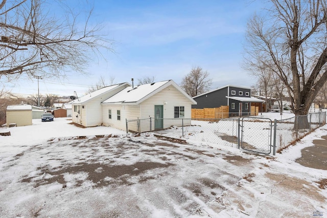 view of snow covered back of property