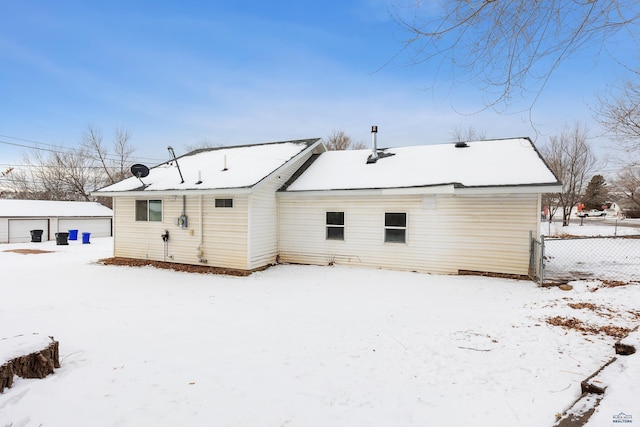 view of snow covered back of property