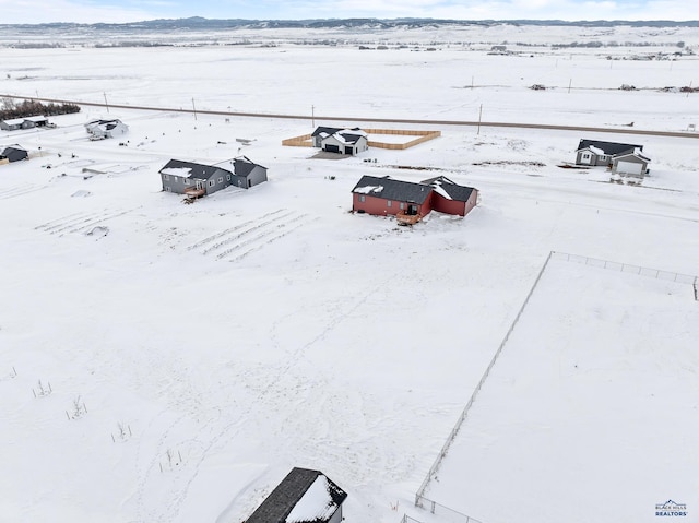 snowy aerial view featuring a rural view