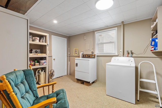 clothes washing area featuring light carpet, built in shelves, separate washer and dryer, and ornamental molding