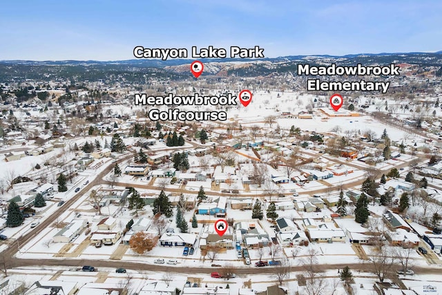 snowy aerial view featuring a mountain view