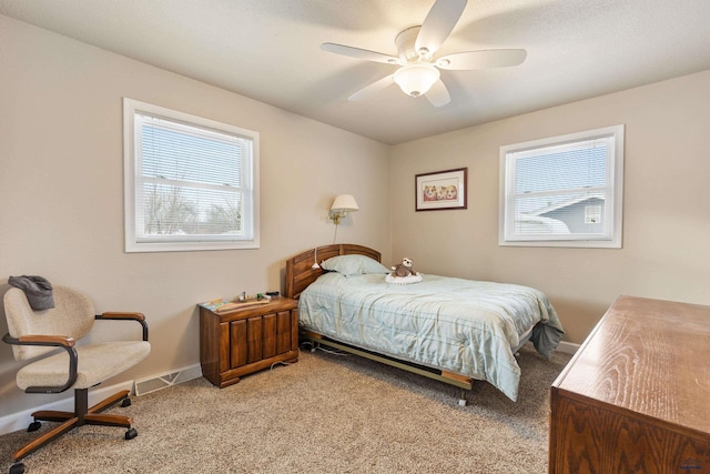 bedroom with carpet flooring, multiple windows, and ceiling fan