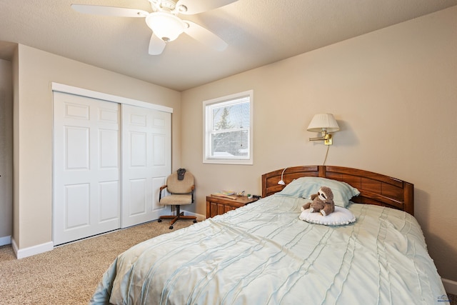 carpeted bedroom with ceiling fan and a closet