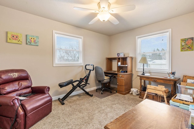 home office featuring carpet flooring, plenty of natural light, and ceiling fan