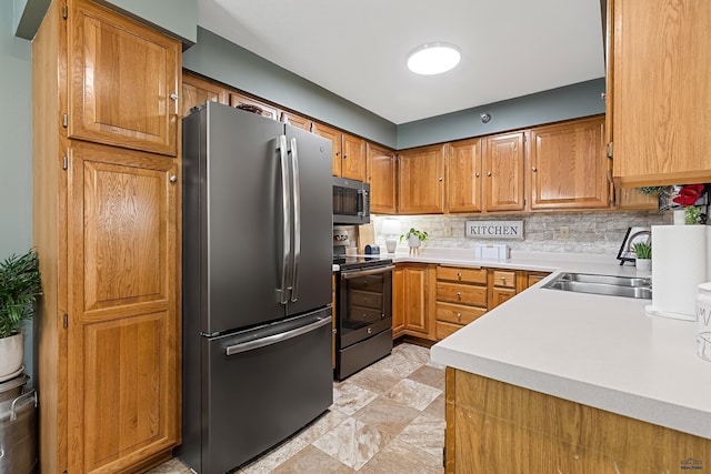 kitchen with backsplash, sink, and appliances with stainless steel finishes