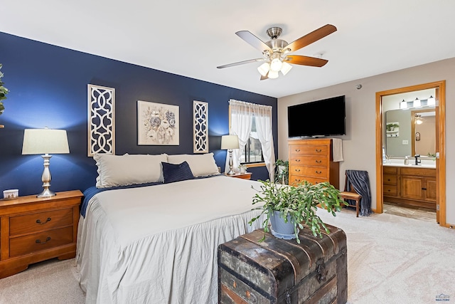 carpeted bedroom with ceiling fan and ensuite bathroom