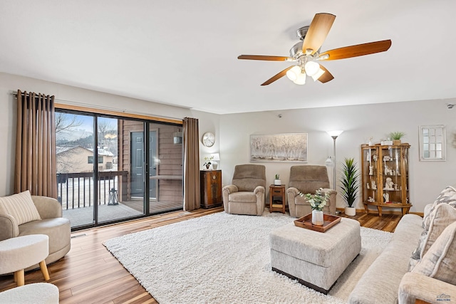 living room with light hardwood / wood-style floors and ceiling fan