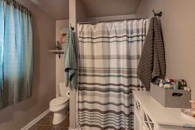 bathroom featuring tile patterned flooring, a shower with curtain, and toilet