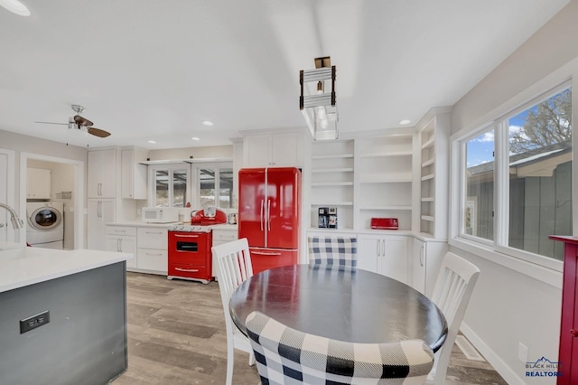 dining space featuring washer / dryer, ceiling fan, and light hardwood / wood-style flooring