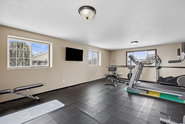 exercise room with a textured ceiling