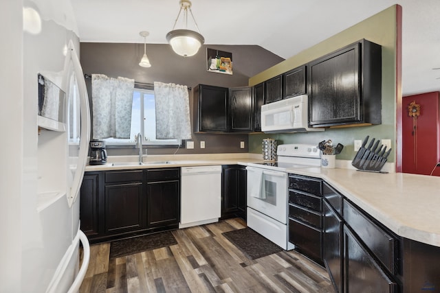 kitchen with white appliances, dark hardwood / wood-style floors, hanging light fixtures, lofted ceiling, and sink