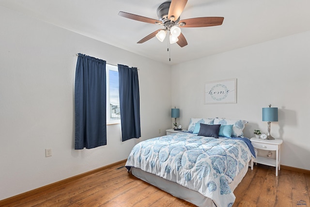 bedroom with ceiling fan and hardwood / wood-style flooring