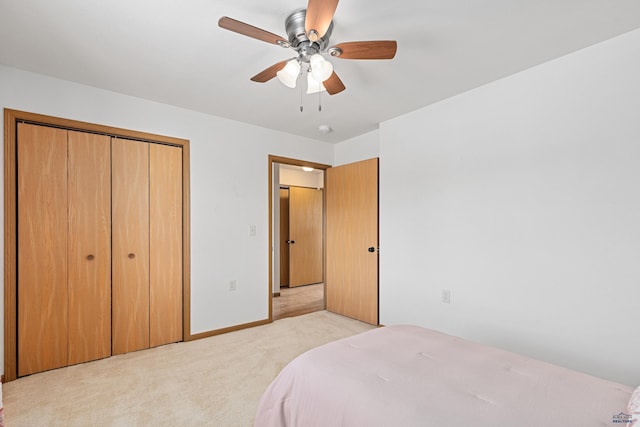 bedroom featuring light carpet, a closet, and ceiling fan