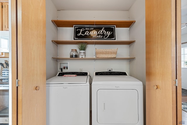 clothes washing area with washing machine and dryer