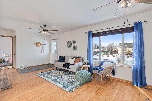 living room with ceiling fan and hardwood / wood-style floors