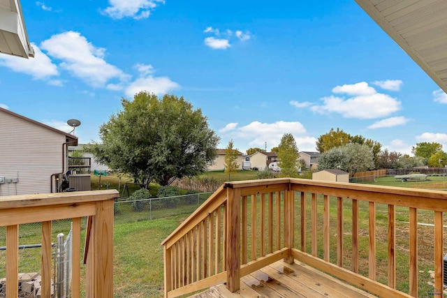 deck featuring a lawn and a shed