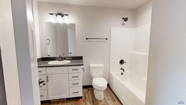 full bathroom featuring toilet, vanity, hardwood / wood-style floors, and shower / bathtub combination