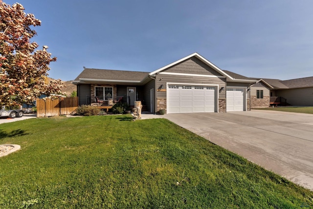 view of front of house with covered porch, a front lawn, and a garage