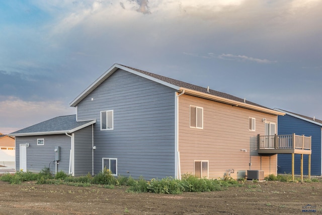 back of property featuring central AC