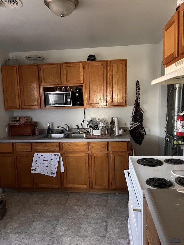 kitchen featuring electric stove and sink