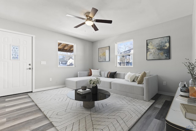 living room with ceiling fan and dark wood-type flooring