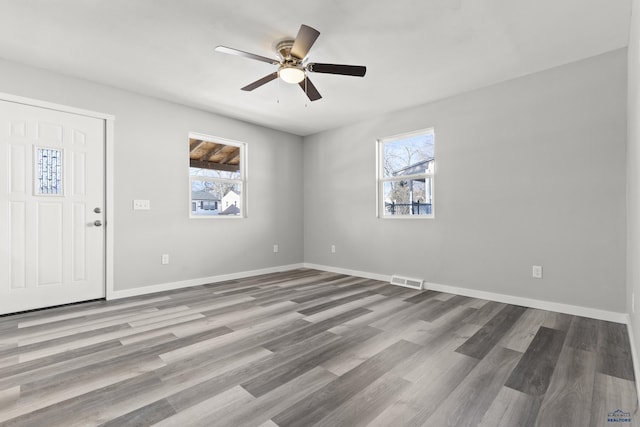 spare room with ceiling fan and light hardwood / wood-style flooring