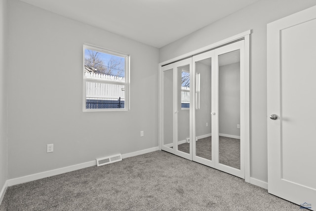 unfurnished bedroom with carpet and a closet