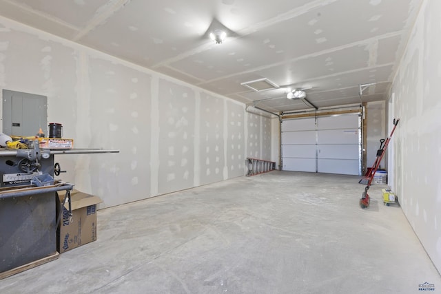 garage with a garage door opener and electric panel