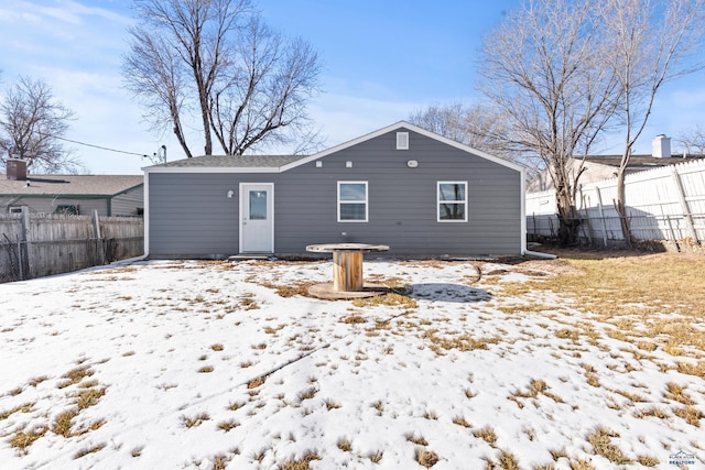 view of snow covered rear of property