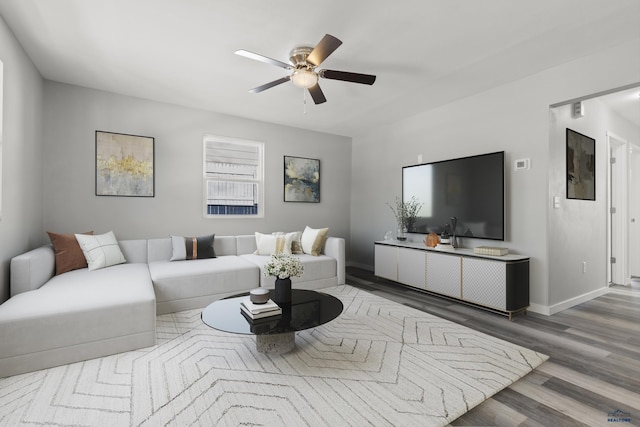 living room featuring ceiling fan and hardwood / wood-style floors