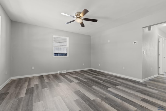 empty room with ceiling fan and hardwood / wood-style floors