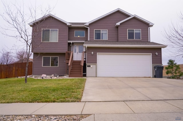 raised ranch with a front lawn and a garage